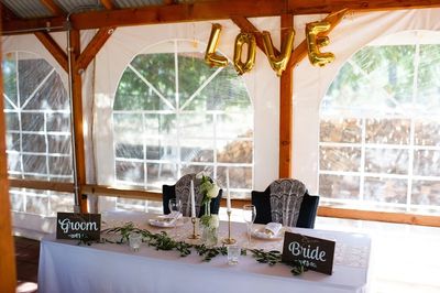 Bride and Groom Table with LOVE sign above.