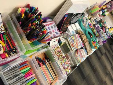 A table full of creative tools and craft items ready for a therapy workshop in Middlesbrough