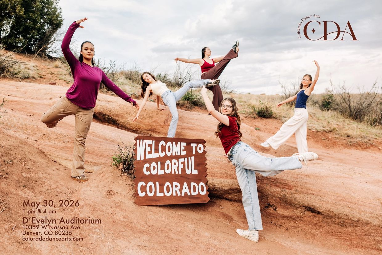 Young dancers pose around a 'Welcome to Colorful Colorado' sign in a desert setting.
