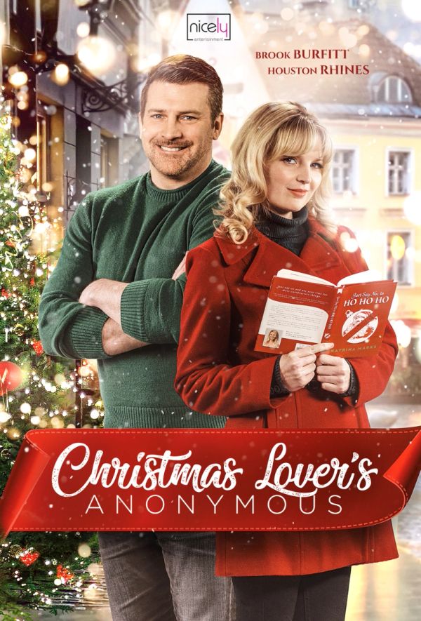 Couple stands together with Christmas decorations and a festive book.