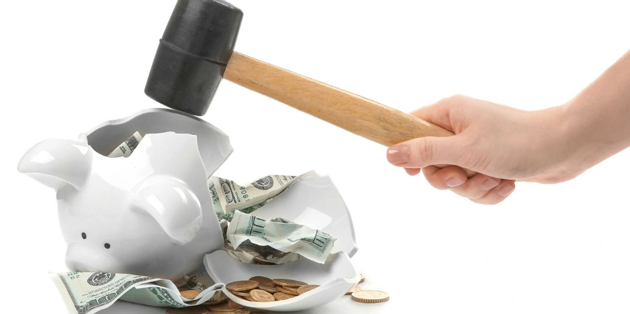 photo of piggy bank being cracked open