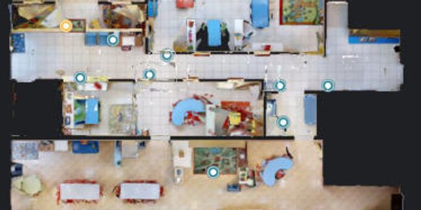 Top-down view of a colorful, multi-room floor plan with furniture and decor.