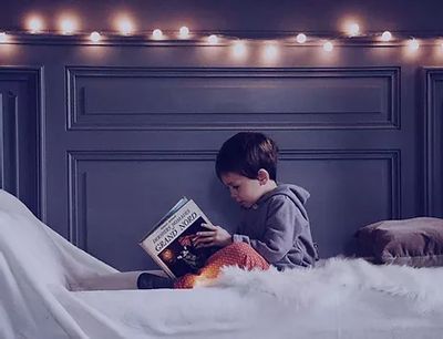 Little child reading from a book