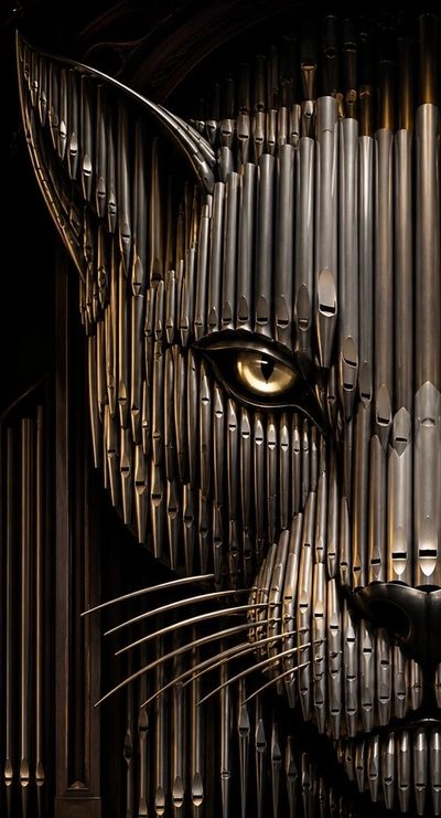 A cat face made from piano pipes.
