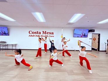Group of children practicing martial arts at Costa Mesa Adult Day Health Care.