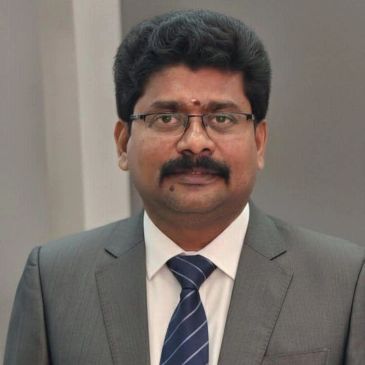 Professional man in suit and tie with glasses and mustache.