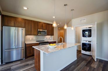 Kitchen is equipped with modern appliances, including a fridge, stove, dishwasher and microwave.