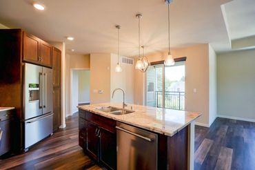 A stocked kitchen with high-end stainless steel appliances is a grand amenity to have.