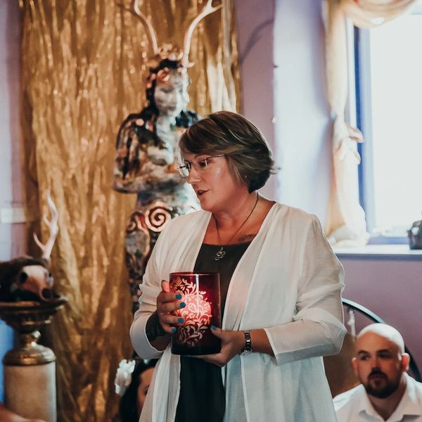 Celebrant with wedding candle.  About to ignite the couple's Handfasting candle