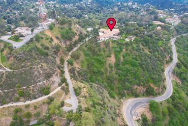Aerial view of a house on a hill marked with a location pin.