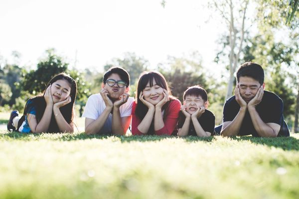 Family posing together for a group photo outside