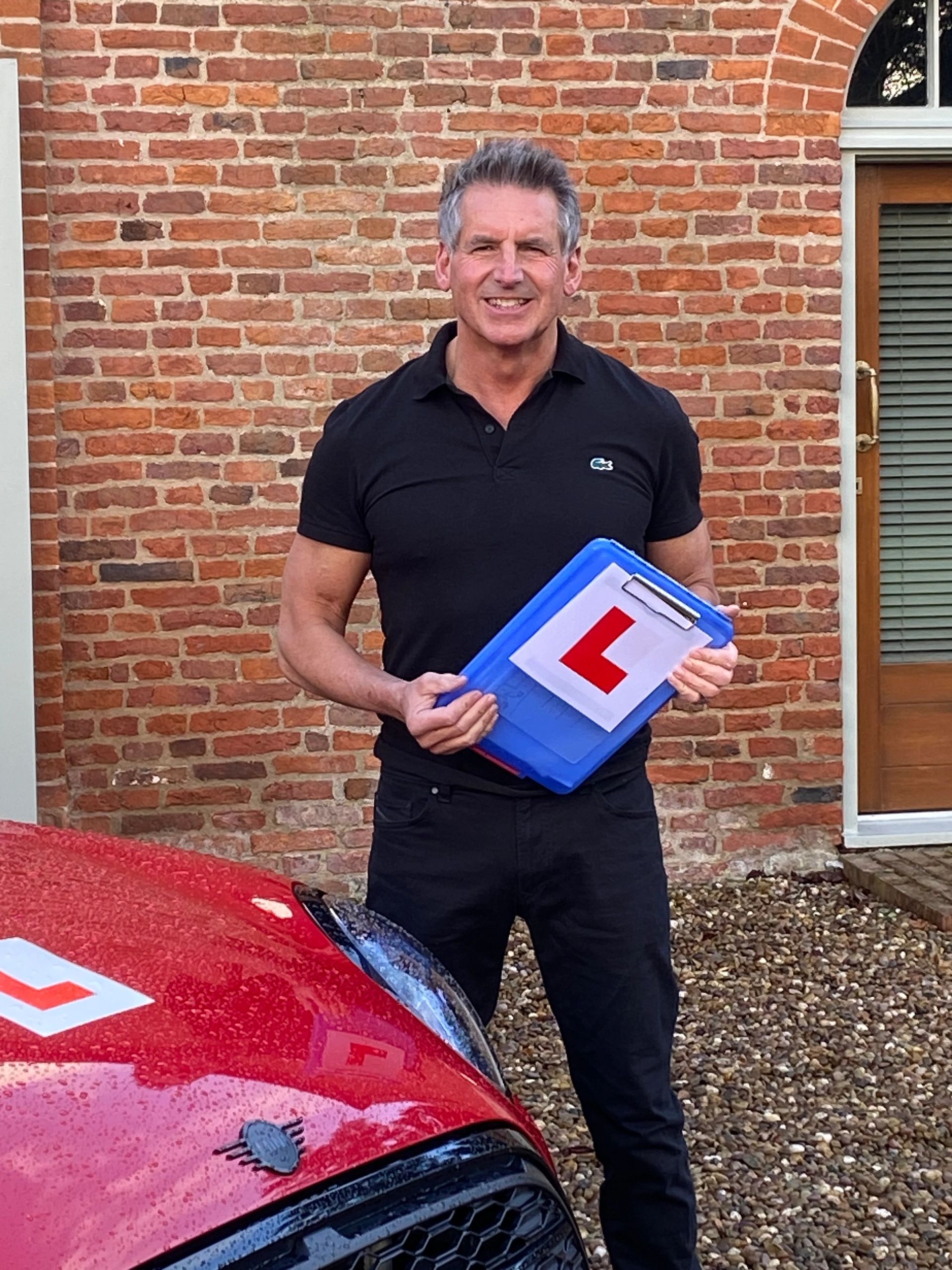 A man holding L bord in his hand