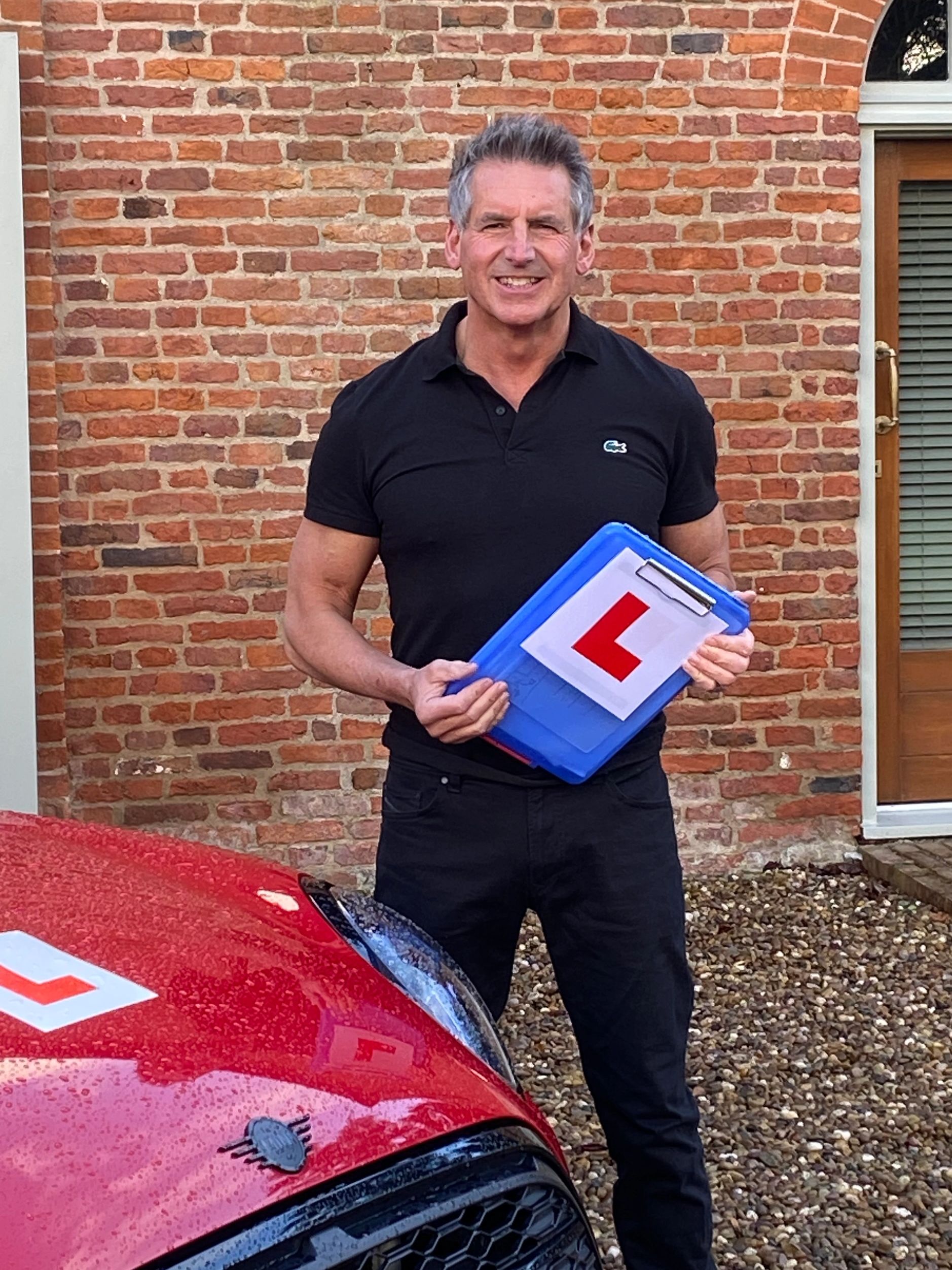 A man holding L bord in his hand