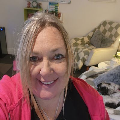 Woman smiling in a cozy living room.
