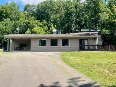 Exterior of Poplar cabin with covered carport and driveway at Star Point Resort on Dale Hollow Lake.