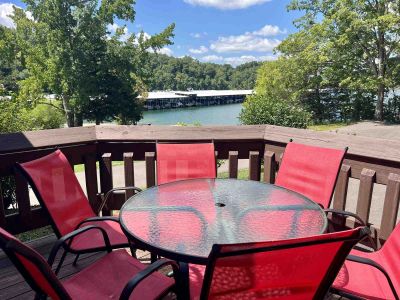 Deck with red patio chairs and glass table overlooking the lake and marina at Star Point Resort on D