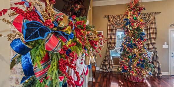 Festive fireplace and Christmas tree decorations in a cozy living room.
