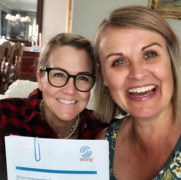 Career coach and client holding Strong Interest Inventory® career assessment cover.