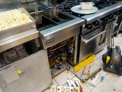 Temperature Tech technician performing commercial repairs on a deep fryer in Penrith.