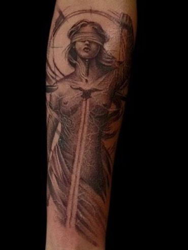 Custom black and grey Lady Justice forearm tattoo by Coty at Mayhem Tattoo, Salem NH