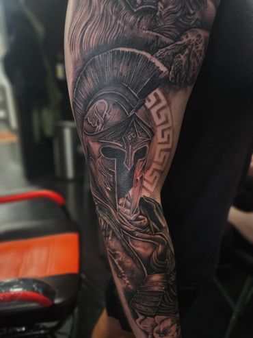 black and grey realistic spartan warrior helmet tattoo sleeve