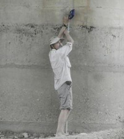 Dr. Timothy Duex, a Geologist,  measures subsidence of 7' 5" of riverbed under  a highway bridge.