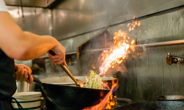 a person making fried rice