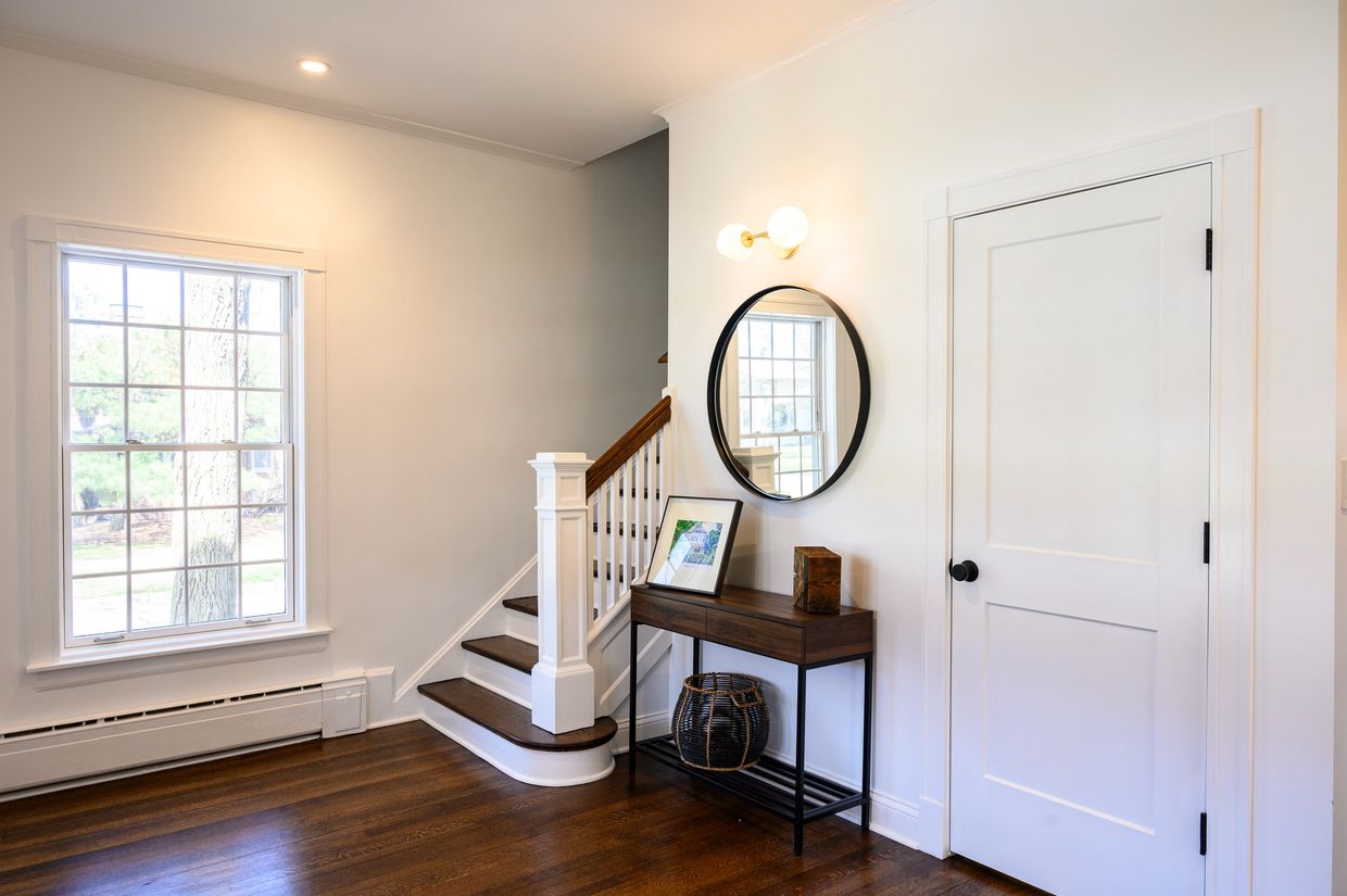 Welcoming and bright front foyer with a much needed coat closet is added where a dated bookcase was.
