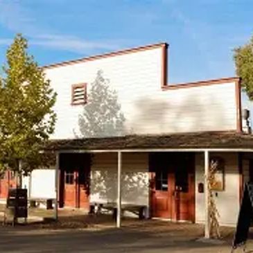 Old western-style building with wooden doors and porch.