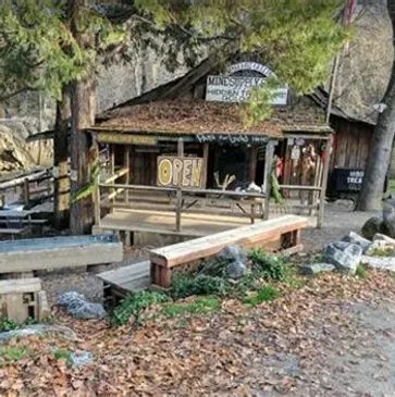 Rustic wooden building with an OPEN sign.
