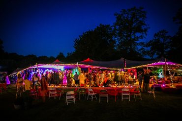 Elegant party tent with ambient lighting for an evening event