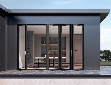 Modern house with smart filminstalled on folding glass doors opening to interior.