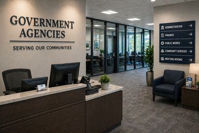 Modern government agency reception area with directional signs.