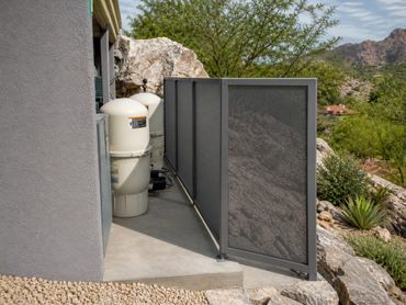 Custom perforated steel equipment enclosure fabricated for ventilation, privacy, and modern desert a