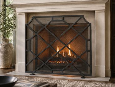Architectural fireplace screen featuring clean intersecting steel lines and artisan metal craftsmans