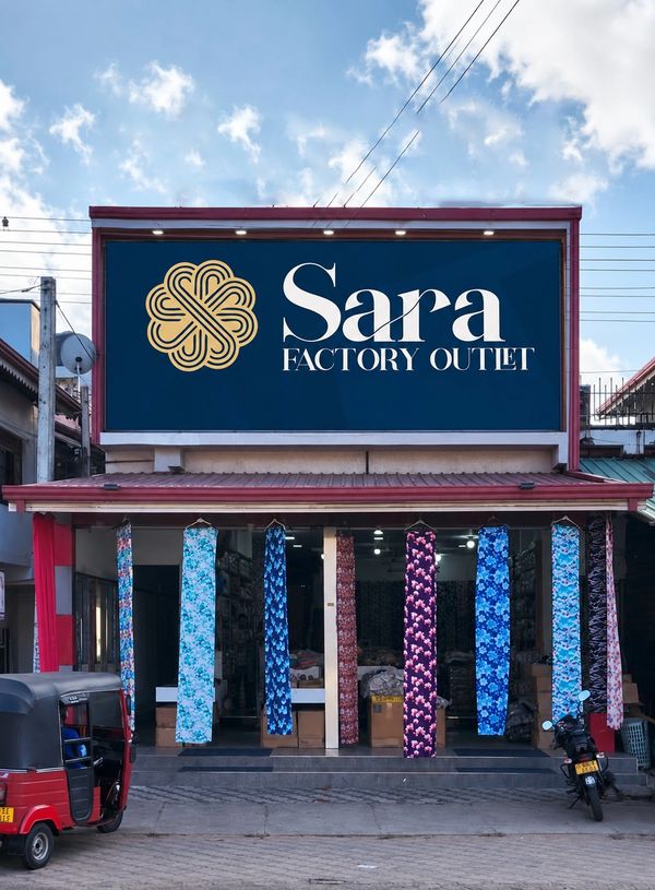 Sara Factory Outlet storefront with hanging fabric rolls.