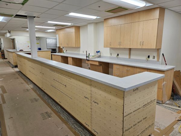 Newly installed counter and cabinets in office space under construction.
