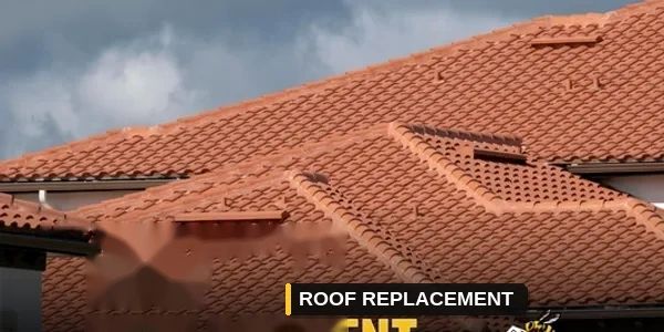 Close-up of a tiled roof under cloudy sky.