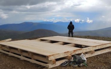 Remote timber construction platform built by Blue Collar Vertical Industries in mountainous terrain.