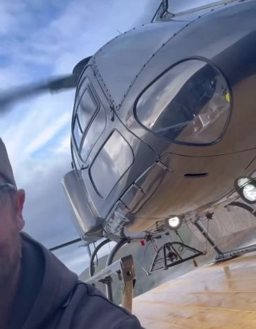 Helicopter positioned on a custom timber helipad built by Blue Collar Vertical Industries.