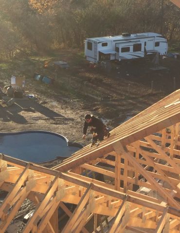 Residential roof framing and structural carpentry during new home construction by Blue Collar Vertical Industries.