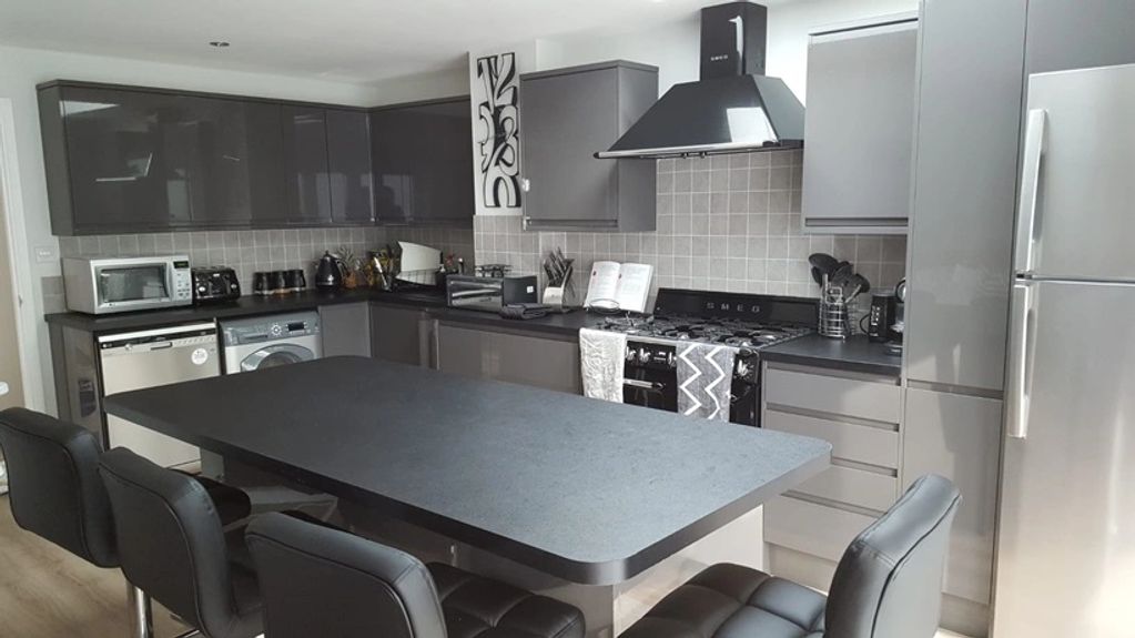 Modern slate grey kitchen with large island unit.