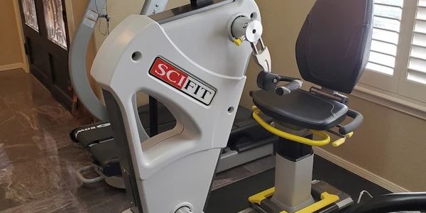 A SciFit recumbent exercise bike in a home gym setting.