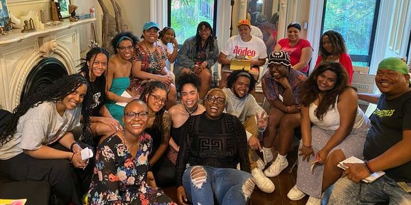 Group of People Sitting in a Living Room Together