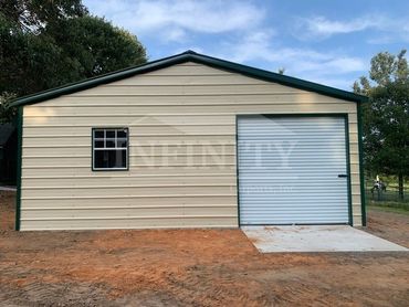 Metal garage building with a single window and roll-up door.