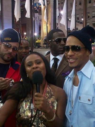 Group of people at an event, woman with microphone.