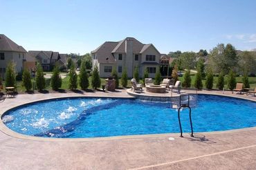 Kidney shaped swimming pool. Inground pool. Custom cement pool