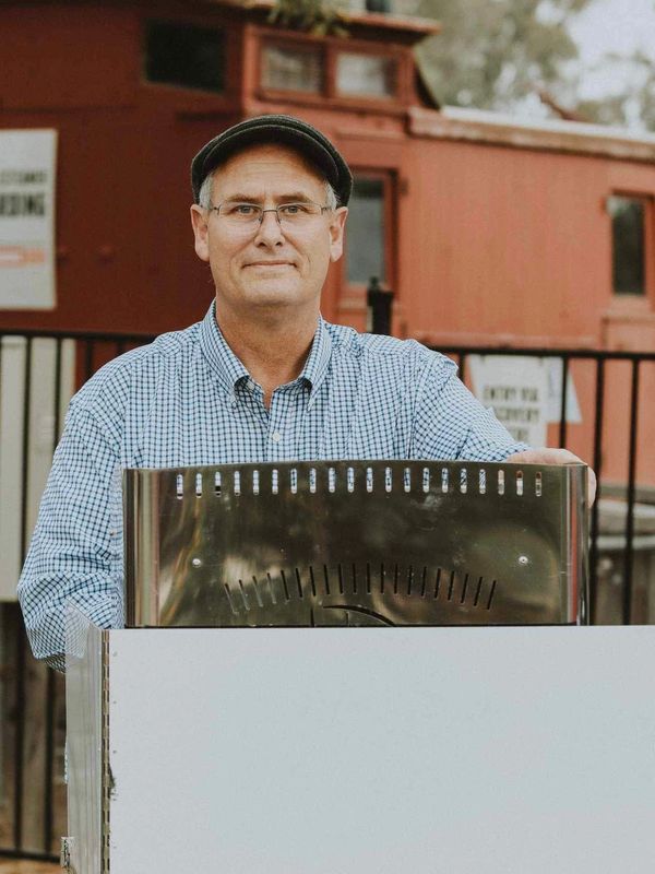 Daniel Mackrell standing behind a a coffee machine at the Port of echuca