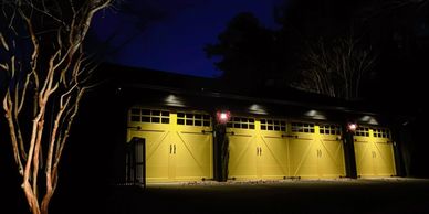 Yellow garage doors illuminated at night.
