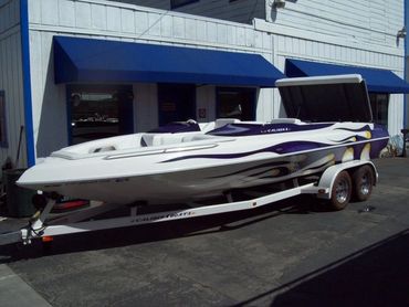 Blue and Yellow Boat in front of Shop